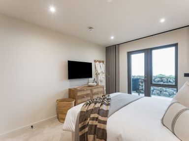 A bedroom with a bed and television at tbc in St. Ives