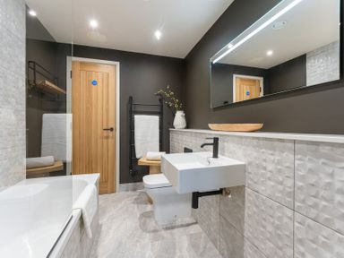 A bathroom with a sink and a bathtub at tbc in St. Ives