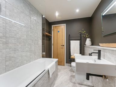 A bathroom with a bathtub, sink, and toilet at tbc in St. Ives