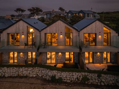 Three houses with balconies and outdoor seating at Hidden 3- Sea Terrace House, St Ives