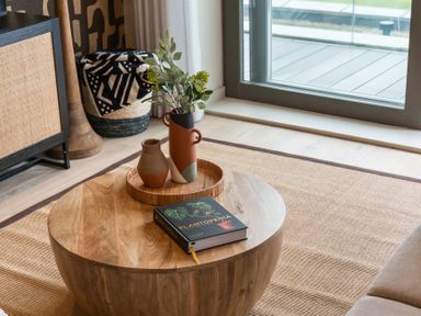 A living room with a coffee table and plants at tbc in St. Ives