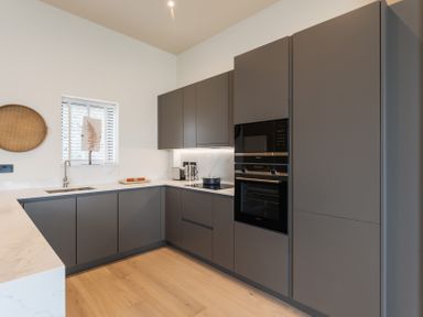 A kitchen with cabinets and appliances at tbc St. Ives
