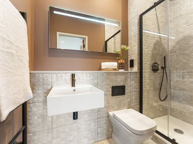 A bathroom with a sink, toilet, and shower at tbc St. Ives