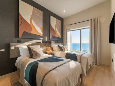A bedroom with two beds and a view at Hidden 9 – Grand Bay Suite Hot Tub St Ive