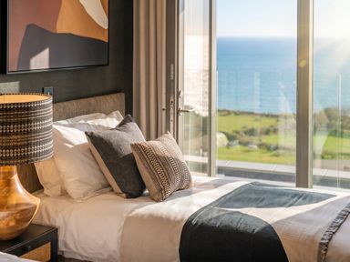 A bedroom with a bed and seaside view at Hidden 9 – Grand Bay Suite Hot Tub, St Ive