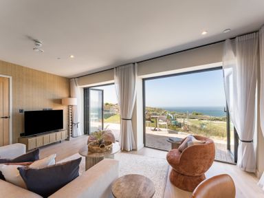 A living room with a television and a view at tbc in St. Ives