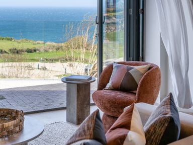 A living room with a chair and coffee table at tbc in St. Ives