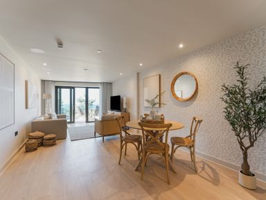 A living room with a dining table and sofa at tbc in St. Ives