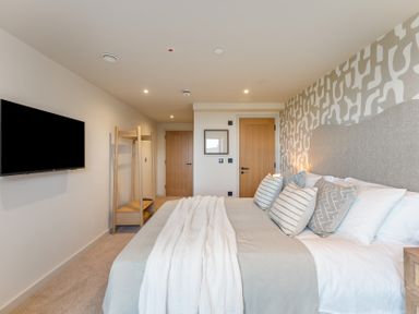A bedroom with a bed and television at tbc in St. Ives