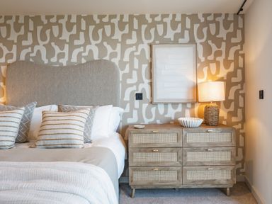 A bedroom with a bed and dresser at tbc in St. Ives