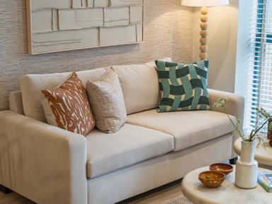A living room with a sofa and decor at Hidden 19- Coastal Hot Tub in St Ives