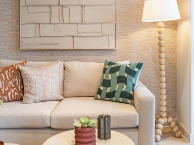 A living room with a sofa and lamp at Hidden 19- Coastal Hot Tub St Ives