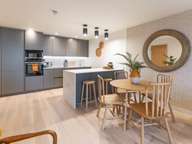 A kitchen with a table and chairs at Hidden 19- Coastal Hot Tub in St Ives