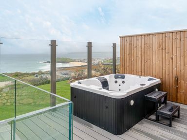 An outdoor area with a hot tub and ocean view at tbc in St. Ives