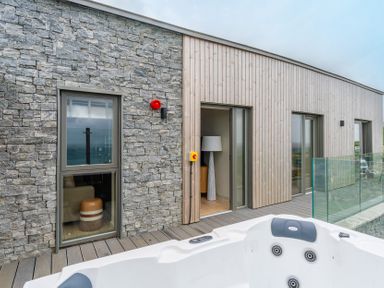 An outdoor area with a hot tub and windows at tbc St. Ives