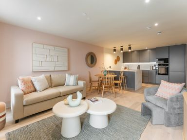 A living room with a sofa and dining table at tbc in St. Ives