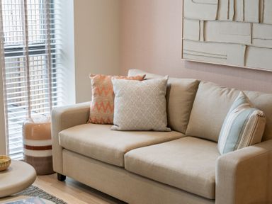 A living room with a sofa and cushions at tbc in St. Ives