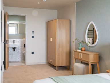 A bedroom with a wardrobe and vanity table at tbc in St. Ives