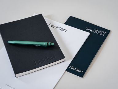 A notebook and guest directory with a pen at Hidden 20- Gallery Hot Tub St Ives
