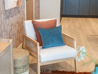 A living room with an armchair and cushions at tbc in St. Ives