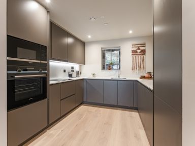 A kitchen with cabinets, oven and sink at tbc in St. Ives
