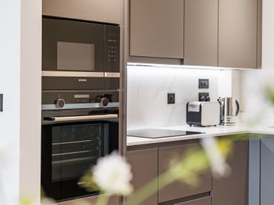 A kitchen with an oven and microwave at tbc in St. Ives