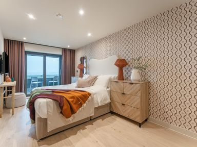 A bedroom with a bed and television at tbc in St. Ives