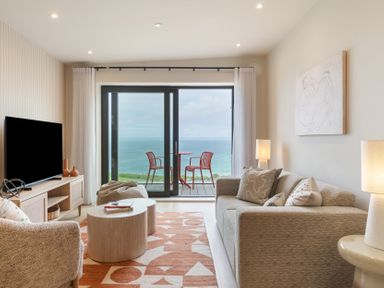 A living room with a sofa and a coffee table at Hidden 10- Godrevy View in St Ives