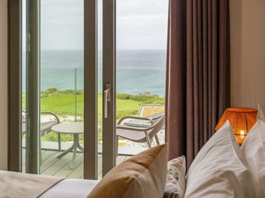 A bedroom with a view of the ocean at Hidden 10- Godrevy View in St Ives