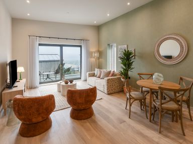A living room with seating and dining area at tbc in St. Ives