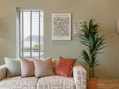 A living room with a sofa and cushions at tbc in St. Ives
