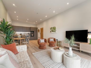 A living room with a sofa, dining area and kitchen at tbc in St. Ives