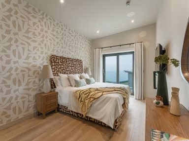 A bedroom with a bed and sliding door at tbc in St. Ives