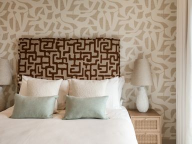 A bedroom with a bed and decorative pillows at tbc in St. Ives