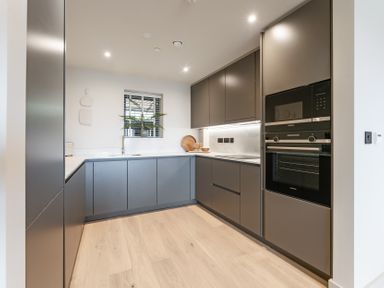 A kitchen with cabinets and an oven at tbc in St. Ives