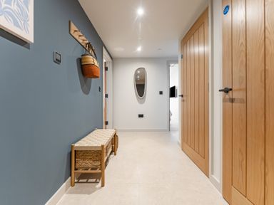 A hallway with a bench and wall hooks at tbc in St. Ives