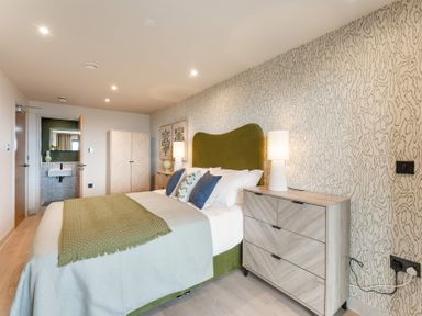 A bedroom with a bed and dresser at tbc in St. Ives