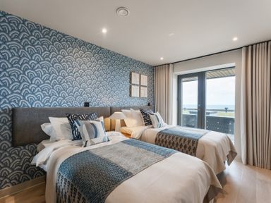 A bedroom with two beds and a window at tbc St. Ives