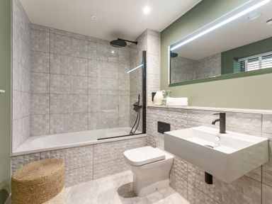 A bathroom with a bathtub, shower, toilet, and sink at tbc in St. Ives