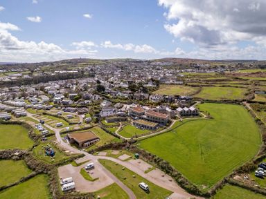 An aerial view of a residential area with camper vans and fields at tbc St. Ives