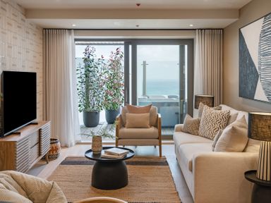 A living room with a sofa and television at tbc in St. Ives
