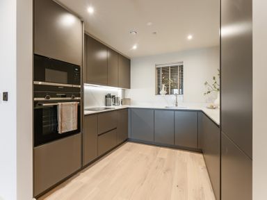 A kitchen with cabinets, oven, sink and window at tbc in St. Ives