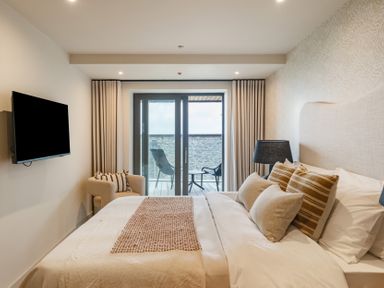 A bedroom with a bed and television at tbc in St. Ives