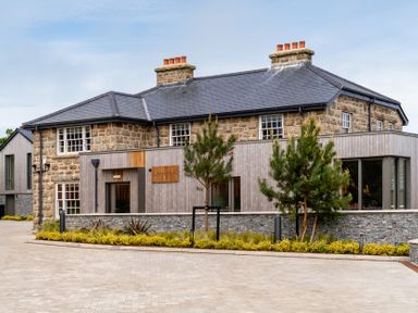 An exterior view of a building with windows and plants at Hidden 15- Garden Hot Tub in St Ives