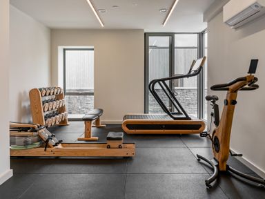 A gym with various exercise equipment at Hidden 15- Garden Hot Tub St Ives