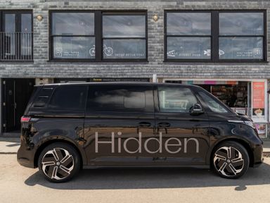 A black vehicle parked in front of a restaurant at Hidden 15- Garden Hot Tub St Ives