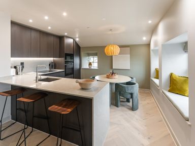 A kitchen with a central island and dining area at tbc in St. Ives