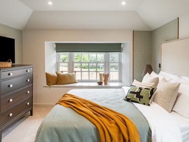 A bedroom with a bed and a dresser at tbc in St. Ives