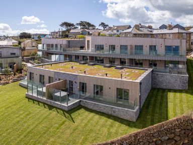 A building with grass roof and balcony at tbc in St. Ives