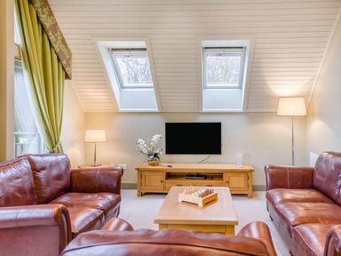 A living room with a television and seating area at The Derwent Spa (Pet) Slaley